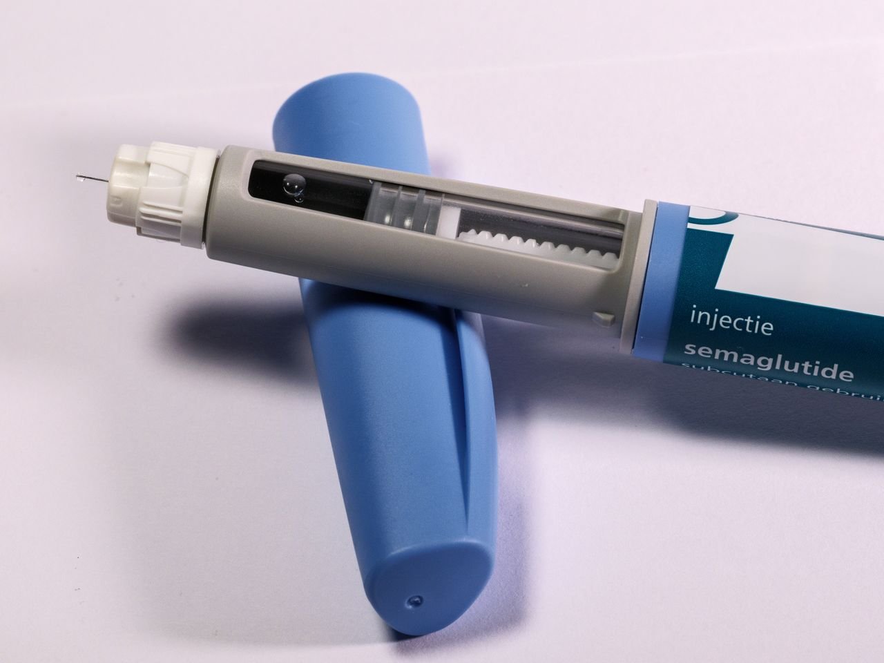 Crafting Captivating Headlines: Your awesome post title goes here Detailed view of a semaglutide injection pen, commonly used for diabetes treatment, on a plain background.